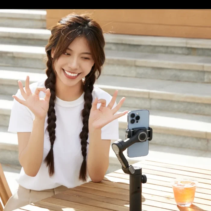 Gimbal on a tabletop tripod recording a young woman